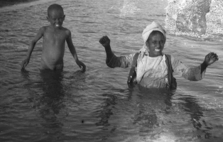 Photograph of two boys playing in the Nile.