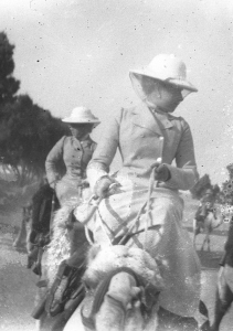 Photograph of ladies riding camels.